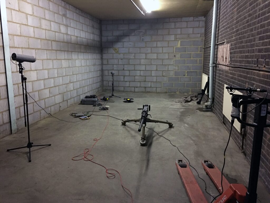 This image of a sound effects library on Sonniss shows a setup for recording unique firearm SFX in a concrete warehouse.