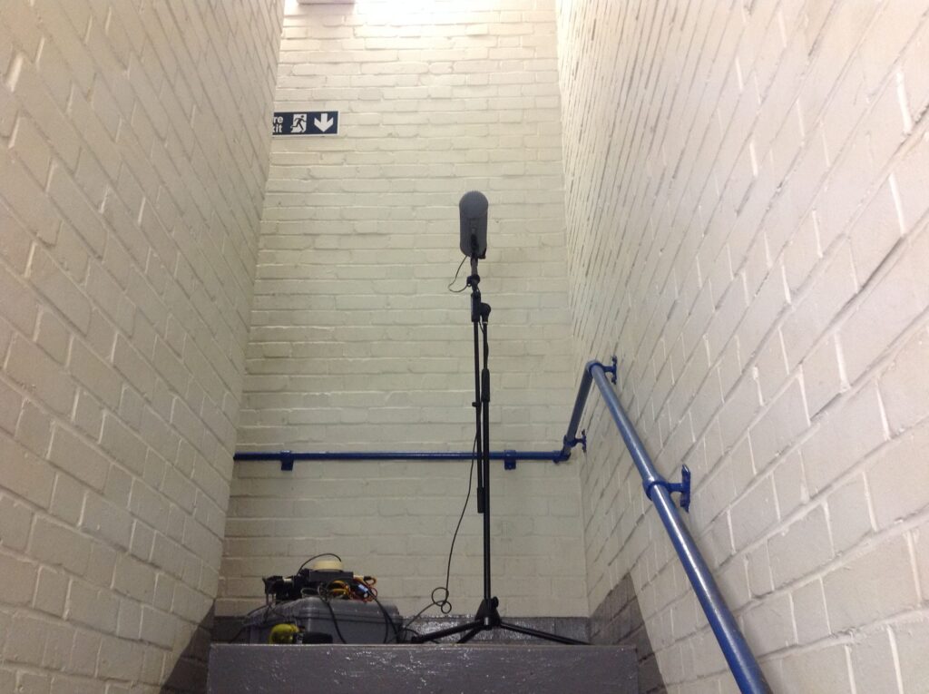 A sound effects library setup: microphone and recorder in a stairwell capture footsteps for realistic sfx on Sonniss.