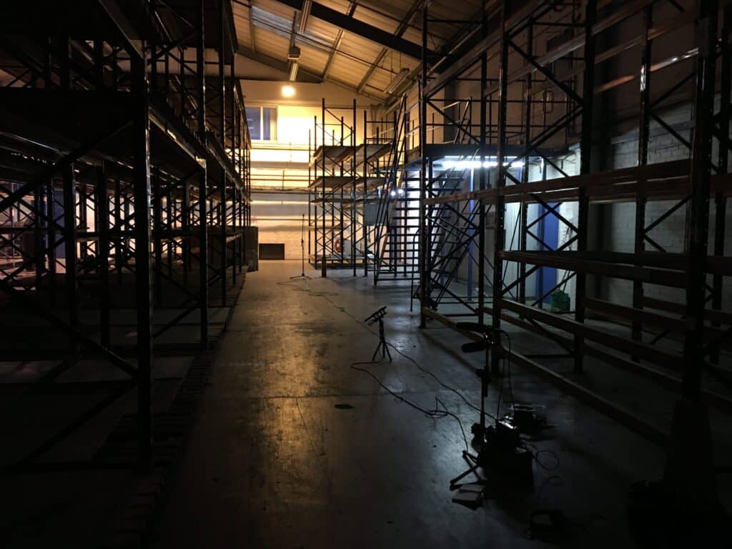 Discover unique firearm sound effects for your sfx library—recorded in a dim warehouse with metal shelves and beams on Sonniss.