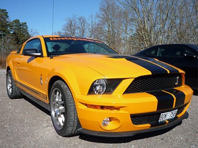 A Ford Mustang Shelby GT500 sound effects library: yellow car on gravel outdoors, perfect source for realistic auto SFX.