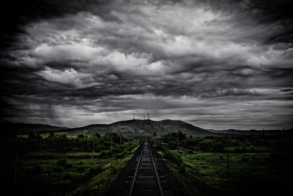 A railway track under stormy clouds—perfect for creators seeking ambient railway sound effects in our sfx library on Sonniss.