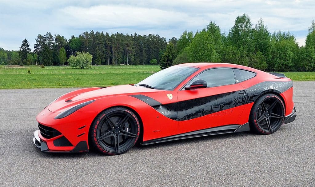 Image of a sound effects library resource on Sonniss: A red sports car with black accents parked on a paved surface, surrounded by green trees and grass under a cloudy sky.