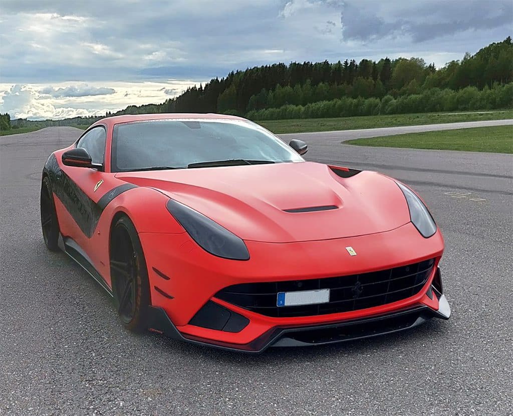 An image of a sound effects library on Sonniss featuring a red Ferrari sports car parked on an empty road with forested scenery.