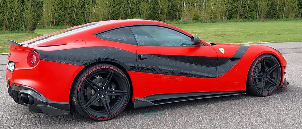 A red sports car with black accents parked on pavement features in our sound effects library, perfect for automotive sfx needs.