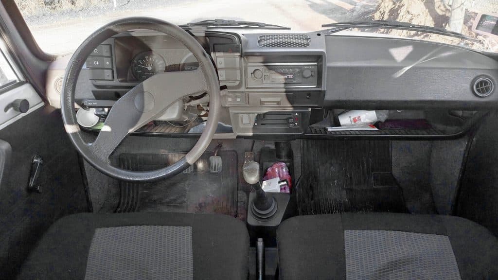 Interior of vintage car for classic dashboard sound effects library—steering, gear shift, and manual controls on Sonniss.