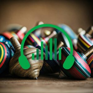 Image of a sound effects library on Sonniss: spinning tops SFX, headphones, and bars on wood background for sound design.