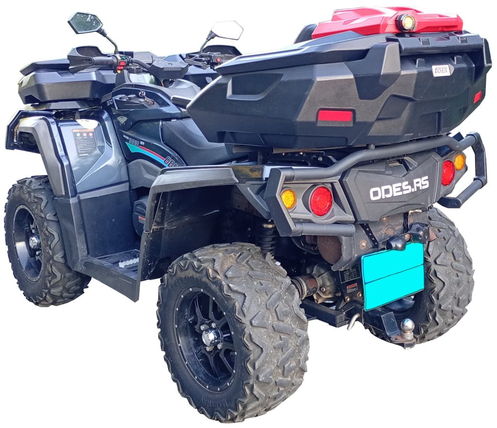 Black ODES all-terrain vehicle (ATV) equipped with rugged tires, large storage boxes, side mirrors, and a red gas can attached to the rear cargo rack.
