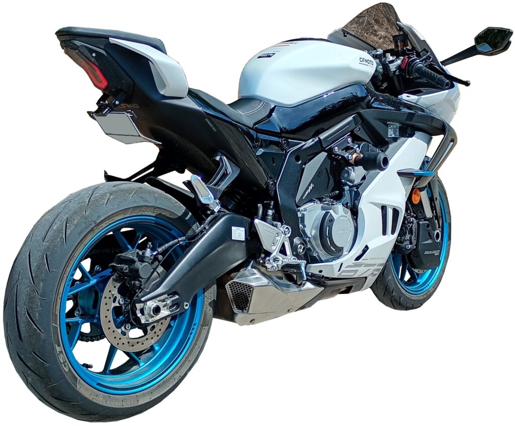White and black sport motorcycle with blue wheels, viewed from the rear left side. The image highlights the streamlined bodywork and large rear tire.