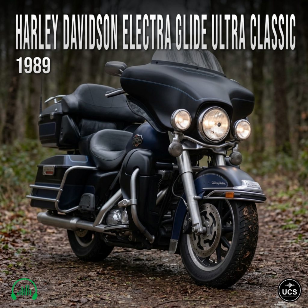 A 1989 Harley Davidson Electra Glide Ultra Classic motorcycle with a black body, chrome details, and touring features parked on a leaf-covered forest path.