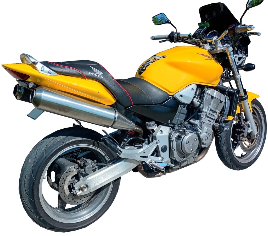 Bright yellow Honda motorcycle with a black seat, silver exhaust, and sporty design, shown from the rear left side against a white background.