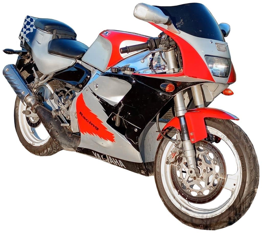 A Yamaha sport-style motorcycle with a red, black, and silver color scheme, large front fairing, exposed engine parts, and checkered details on the seat area.