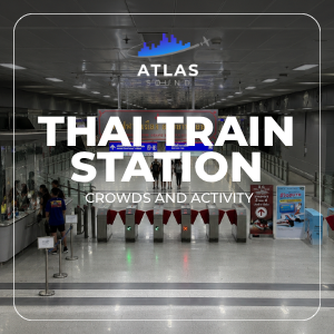 Automated fare gates at a modern Thai train station terminal allow people to walk through.