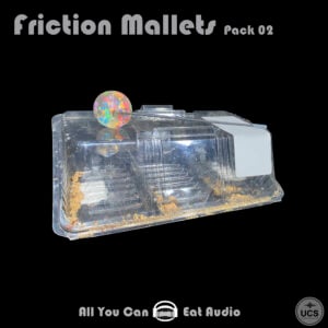 Multi-colored bouncy ball from a Friction Mallets_Pack 02 set rests on a clear plastic food container lid.