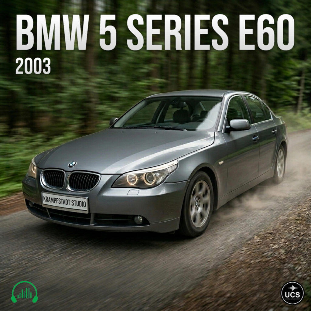 Grey BMW 5 Series E60 2003 executive car speeds along a forest gravel road.
