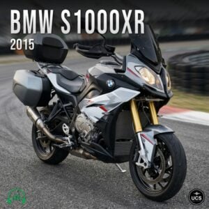 BMW S1000XR 2015 sport touring motorbike with panniers and a top box parked on a racetrack.