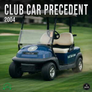 Blue Club Car Precedent 2004 electric golf cart driving across a green course.