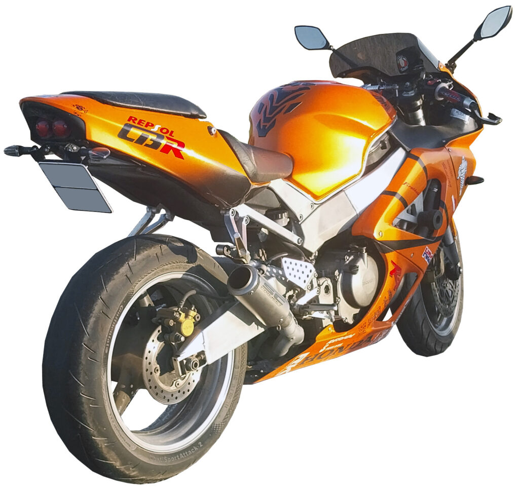 Honda CBR929RR 2000 sport bike motorcycle in orange and black seen from the rear three-quarter angle.