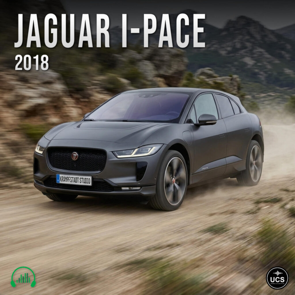 Jaguar I-Pace 2018 electric compact crossover SUV in dark grey drives along a dirt track through mountainous terrain.
