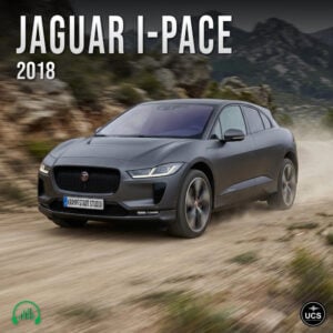 Jaguar I-Pace 2018 electric compact crossover SUV in dark grey drives along a dirt track through mountainous terrain.