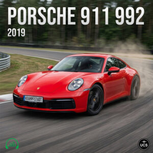 Red Porsche 911 992 2019 sports car drifts on a paved racetrack.