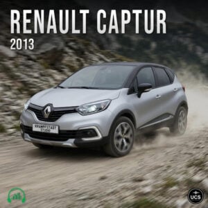 Silver 2013 Renault Captur subcompact crossover SUV drives fast on a dirt track with dust rising behind tyres.