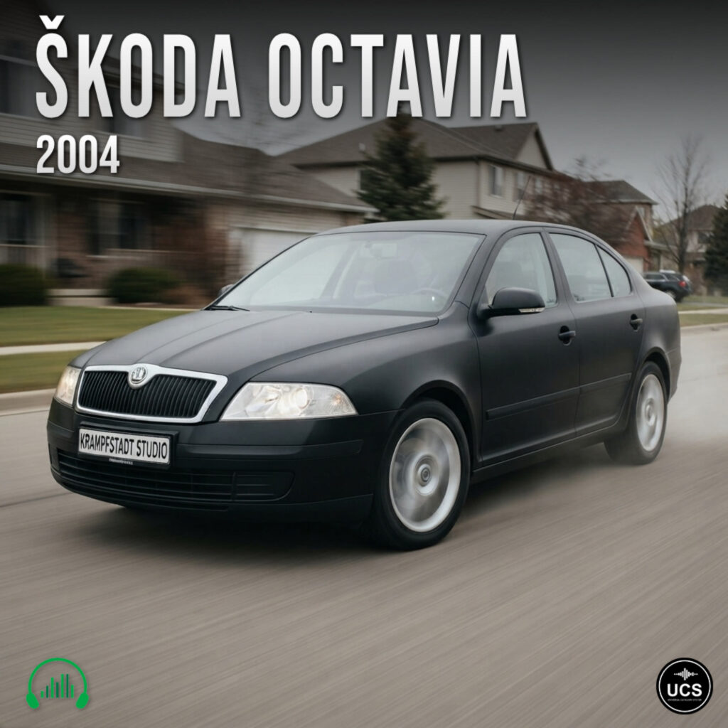 Matte black 2004 Škoda Octavia compact car driving along a suburban street with motion blur.