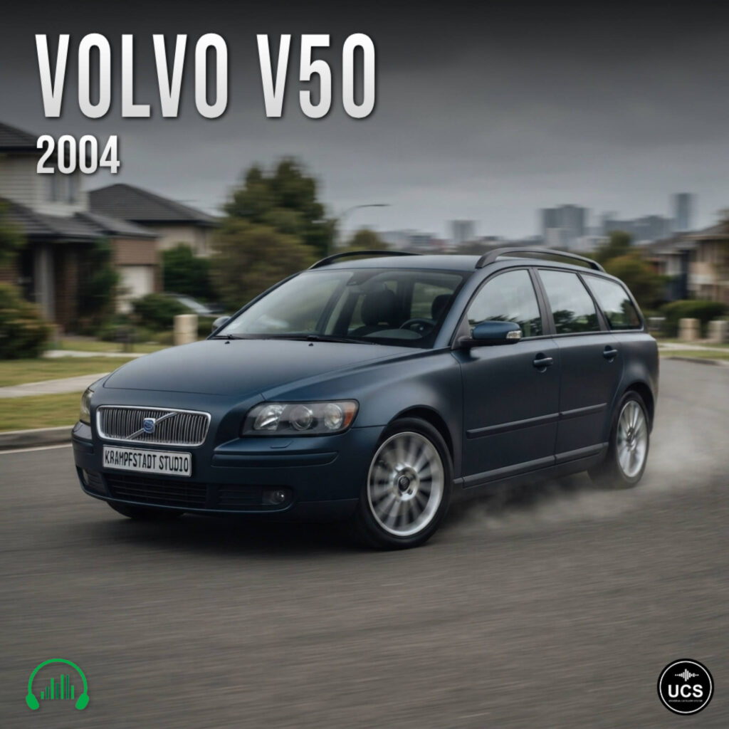 A dark blue 2004 Volvo V50 compact station wagon drives along a suburban road.