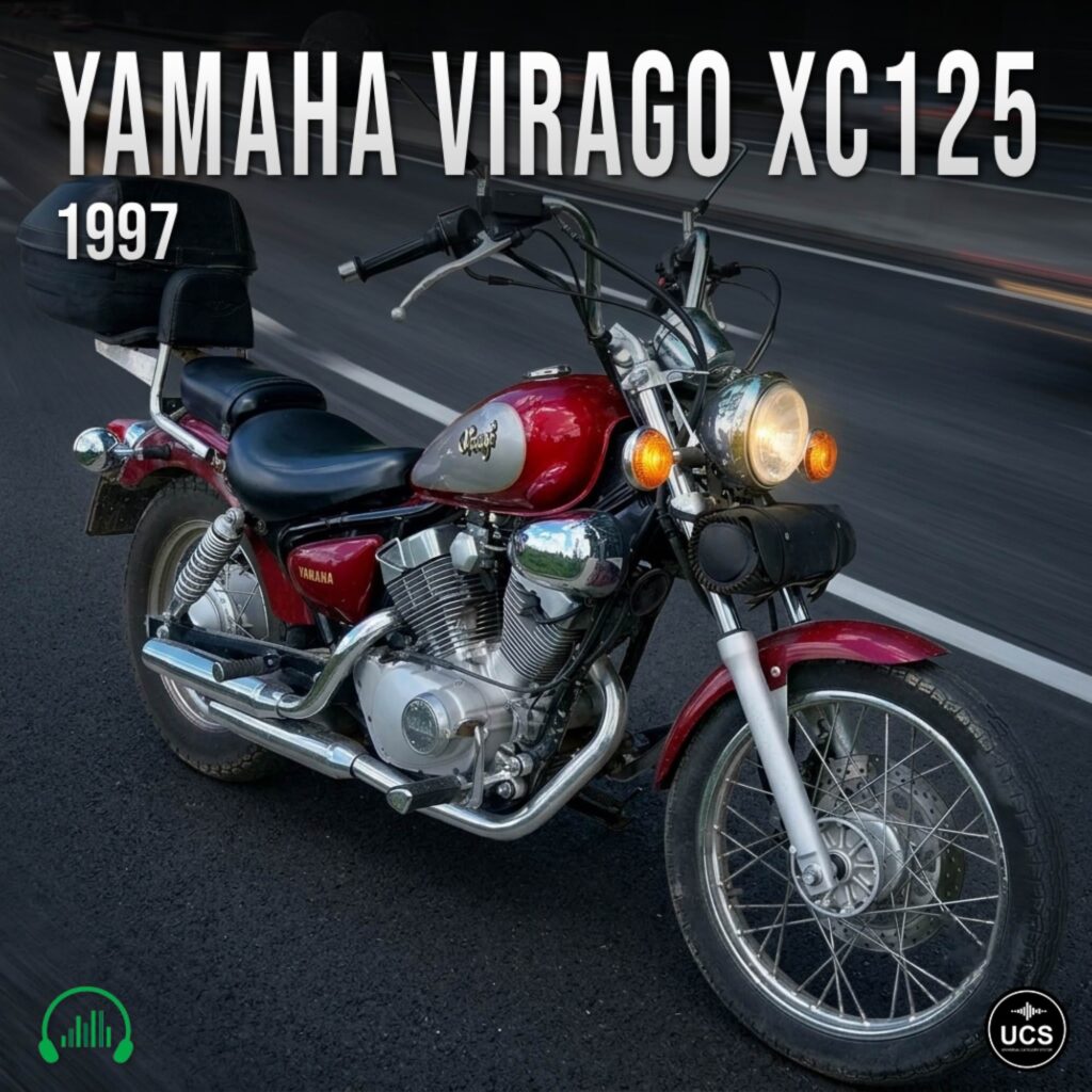 Red 1997 Yamaha Virago XC125 cruiser motorbike with a backrest and black storage bag parked on a tarmac road.
